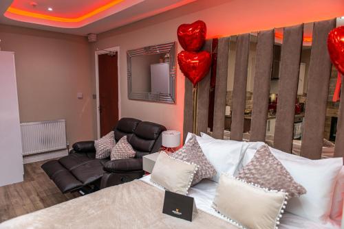 a bedroom with a bed with a heart balloon on the wall at Meridian Serviced Apartments in Bradford