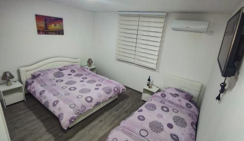 a bedroom with two beds and a window at Apartmani Hani in Trebinje