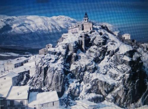 a mountain with a church on top of it at Casa vacanze nel Parco Nazionale della Majella in Montenerodomo