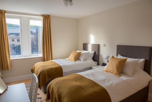 מיטה או מיטות בחדר ב-Toothbrush Apartments - Central Ipswich St Nicholas St
