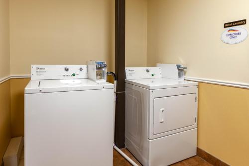 a laundry room with two washers and a refrigerator at Baymont by Wyndham Beulah in Beulah