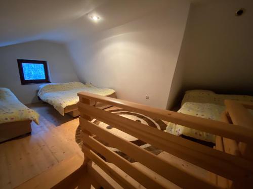 a bedroom with two beds and a window at Sandy Vlašić in Vlasic
