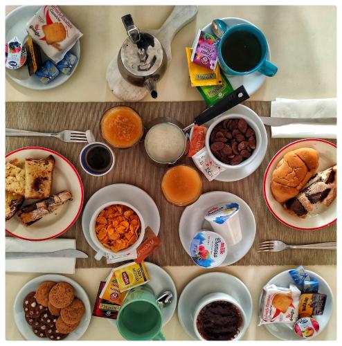 a table filled with different types of breakfast foods at B&B il Faso vicino Zoosafari di Fasano in Fasano