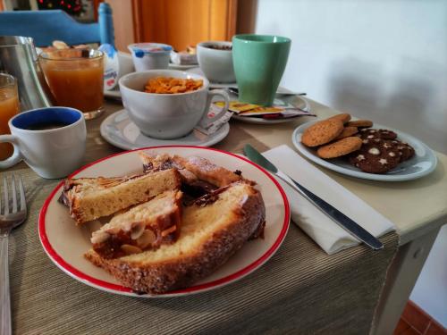 a table with a plate of food with a sandwich at B&B il Faso vicino Zoosafari di Fasano in Fasano