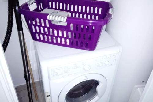 a washing machine with a basket on top of it at baratzean in Uhart-Cize