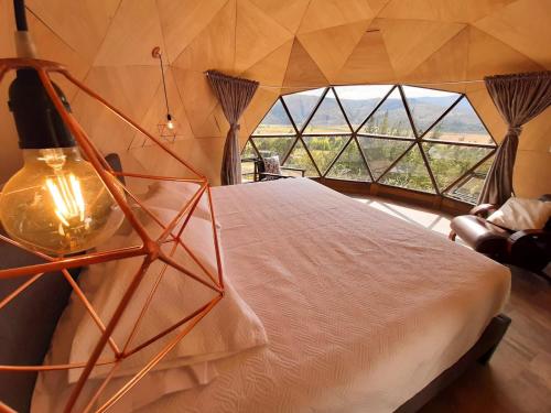 Katil atau katil-katil dalam bilik di Glamping NIDO VERDE