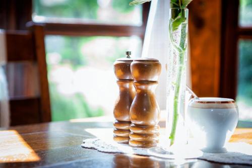 a table with a vase and a cup of coffee at Hotel Dworek Wapionka in Górzno