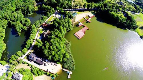 an overhead view of a river with trees and water at Hotel Dworek Wapionka in Górzno