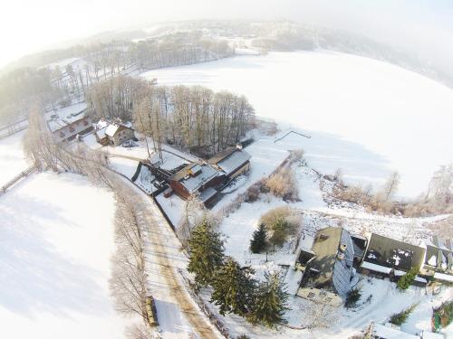 an aerial view of a house in the snow at Hotel Dworek Wapionka in Górzno
