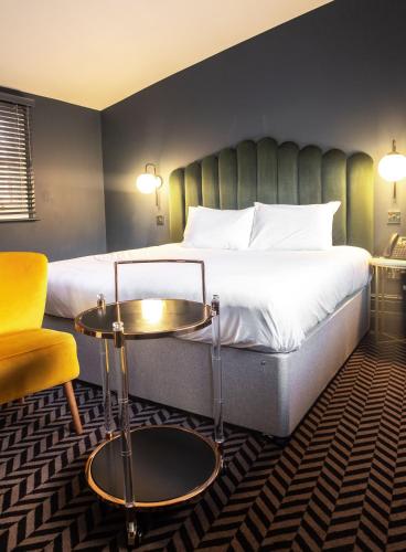 a hotel room with a bed and a table at Lock and Key Boutique Hotel - Duke Street in Liverpool