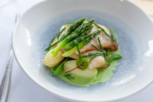 a white plate of food with meat and vegetables at The Seaview Hotel And Restaurant in Seaview