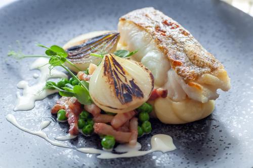 a plate of food with vegetables on a plate at The Seaview Hotel And Restaurant in Seaview