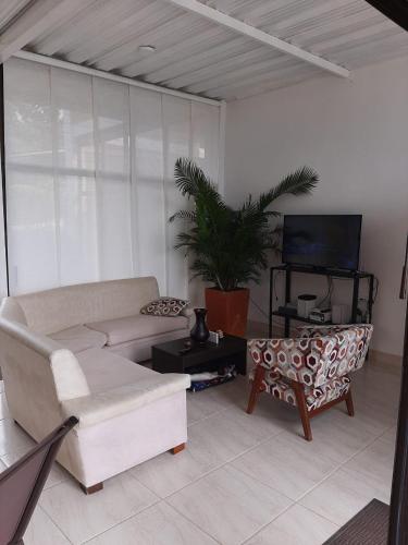 a living room with a couch and a tv at VILLA CARO in Palestina