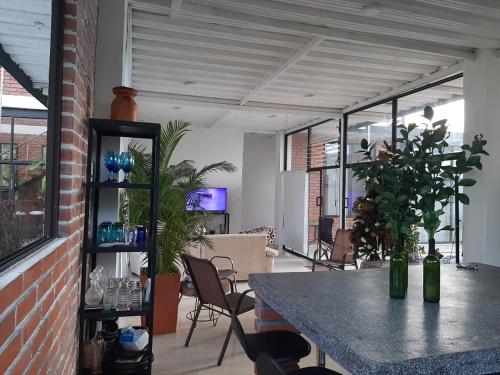 a room with a table and chairs and windows at VILLA CARO in Palestina