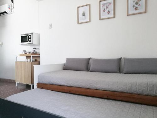 1 sofá en la sala de estar con 1 cama en Departamento para 2 o 4 personas en Neuquén