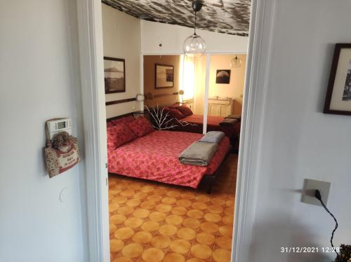 a bedroom with a red couch and a bed at La casa di Rick in Ronciglione