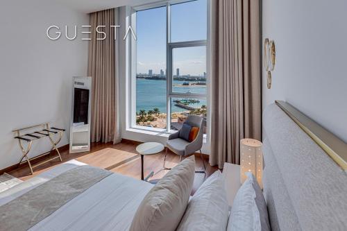 a hotel room with a bed and a view of the ocean at Tiara Residences, Free beach & pool access in Dubai