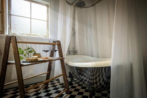 un bagno con vasca e lavandino di Pet-Friendly Blue Mountains Cottage with Indoor Fireplace a Mount Victoria
