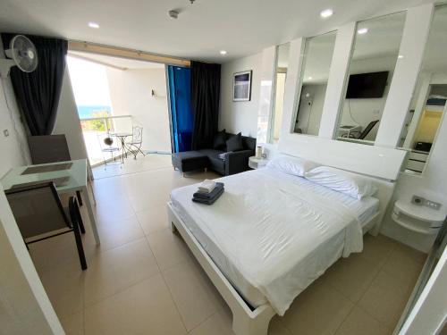 a bedroom with a bed and a living room at Sands Condo Pattaya 13 in Pattaya South