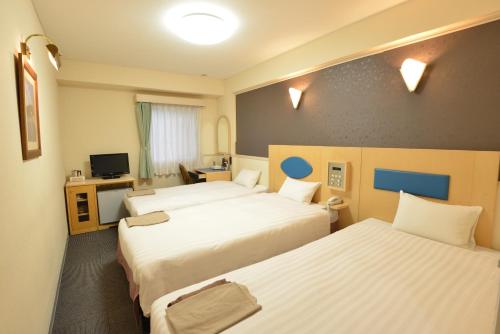 Un pat sau paturi într-o cameră la Hotel Marutani