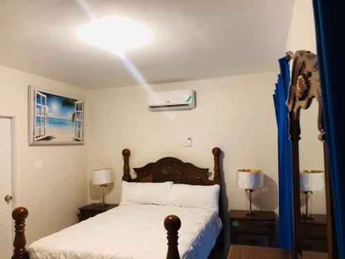 a bedroom with a bed and a light on the ceiling at Retreat by the Beach Lovely New 2 Bedroom in Discovery Bay