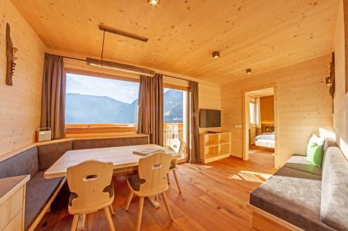 a wooden room with a table and chairs and a bed at Thalhofer Hof in Lazfons