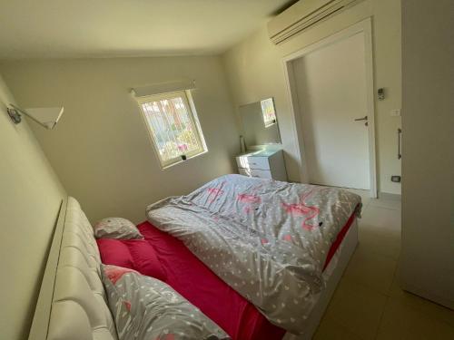 a small bedroom with a bed and a window at De luxe Veranda in Hurghada