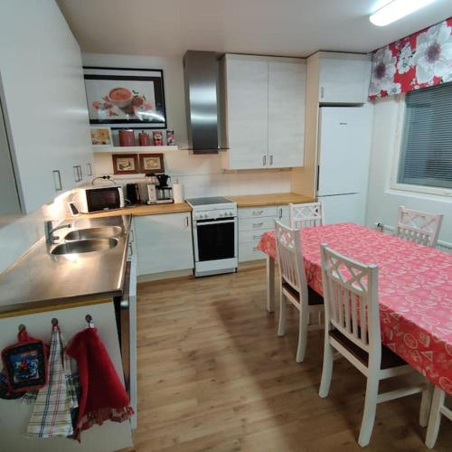 a kitchen with a table and a sink and a table and chairs at Nilsiä city, Tahko, 80 m2, Incude x2 Ski Pass in Tahkovuori