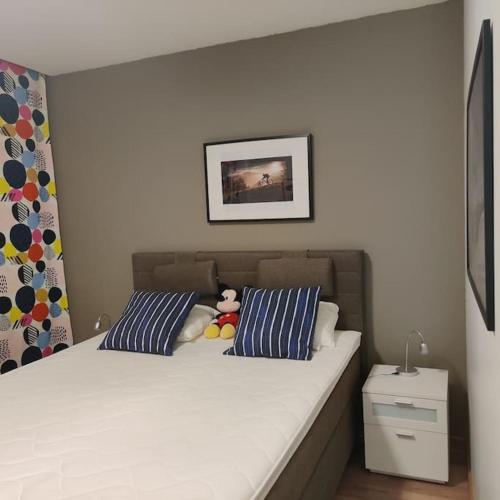 a bed with two pillows and a stuffed animal on it at Nilsiä city, Tahko, 80 m2, Incude x2 Ski Pass in Tahkovuori