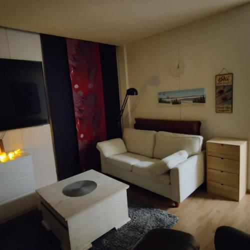 a living room with a couch and a coffee table at Nilsiä city, Tahko, 80 m2, Incude x2 Ski Pass in Tahkovuori