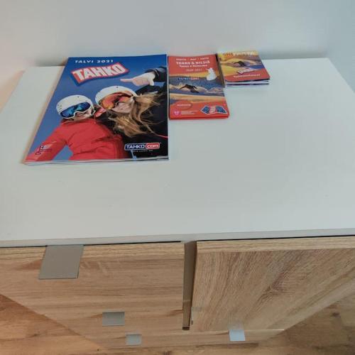 two magazines sitting on top of a table at Nilsiä city, Tahko, 80 m2, Incude x2 Ski Pass in Tahkovuori