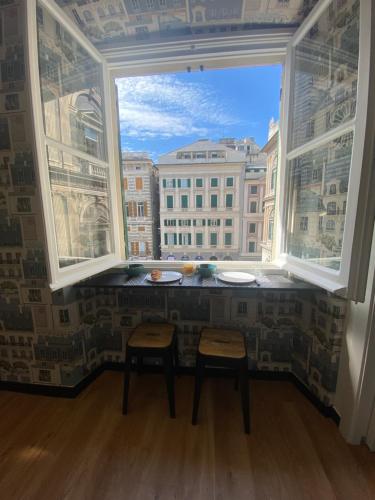 a window with two stools in a room with a view at New Apartament in front of Genoa Cathedral in Genova