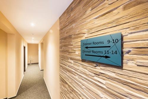 a stone wall in a hallway with a sign on it at Hochwald Lodge in Morbach