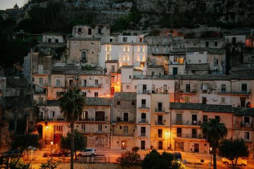 a group of buildings on a hill at night at IBLA ROOMS in Ragusa