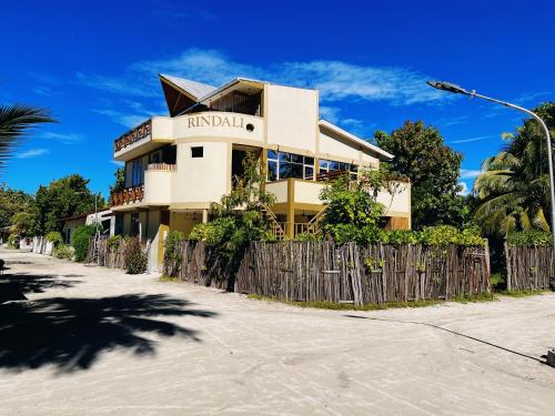 a building with a fence in front of it at Rindali - The speedboat from Malé to the hotel departs at 1130 every Monday Thursday and Saturday and from the hotel to Malé at 0630 and five domestic flights are available every day in Dhaalu Atoll
