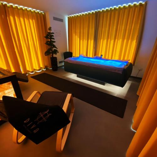 a bedroom with a bed in a room with yellow curtains at DIVA HOTEL LIGNANO - Adults Only in Lignano Sabbiadoro