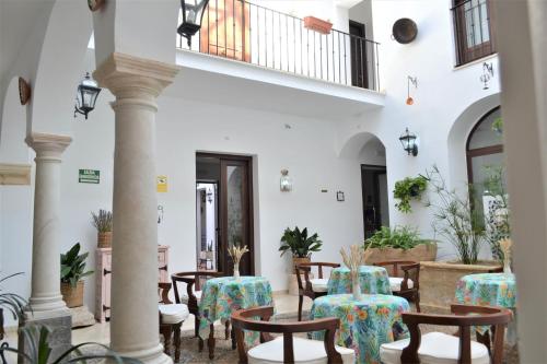 a courtyard with tables and chairs in a building at Hotel Marisa in Córdoba