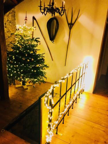 a christmas tree in a hallway with a staircase with lights at Chata Vanda in Štrba