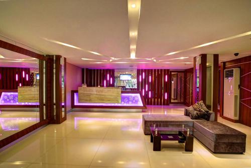 a living room with purple lighting and a couch at Vio Veteran in Bandung