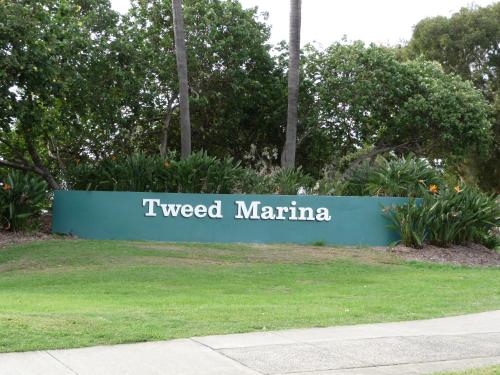 a sign that says tweed marina in a park at Blue Pelican Motel in Tweed Heads