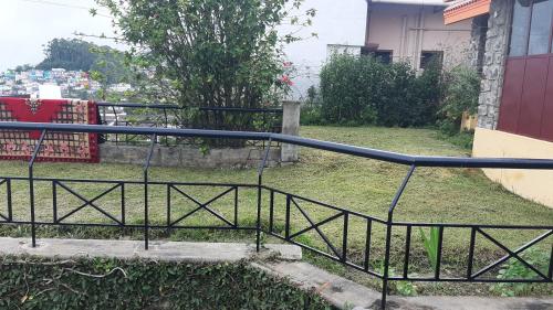 a black metal railing next to a set of stairs at Sunrise Villa in Kodaikānāl