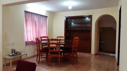 a dining room with a table and chairs at Sunrise Villa in Kodaikānāl