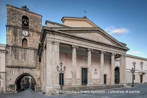 a large building with a clock on the side of it at Casa Jolanda in Forlì del Sannio
