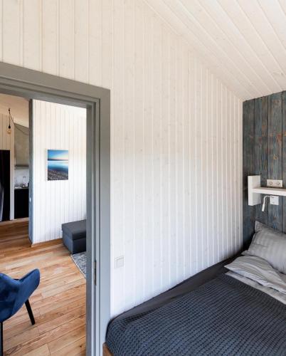 a bedroom with a bed and a mirror at Ganu Māja in Užava