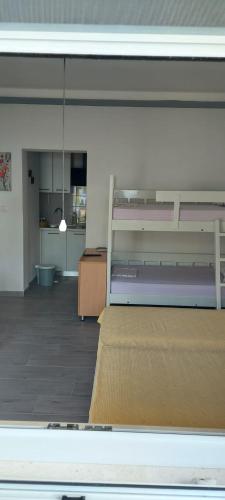 a room with two bunk beds and a kitchen at Top Location in Živogošće