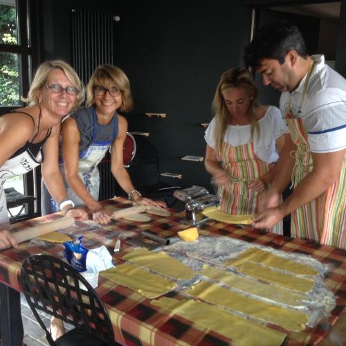 a group of people standing around a table preparing food at B&B Puntodivista in Chieri