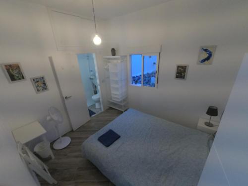 a white bedroom with a bed and a bathroom at Room with Private Bathroom - Vivienda Vacacional Out of Blue in Santa Cruz de la Palma