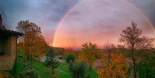 a rainbow in the sky over a river at Agriturismo Casa Greppo in San Venanzo