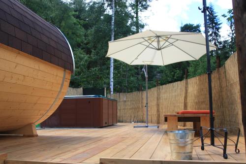 a patio with a table and an umbrella at Camping Du Parc in Pré-Saint-Didier