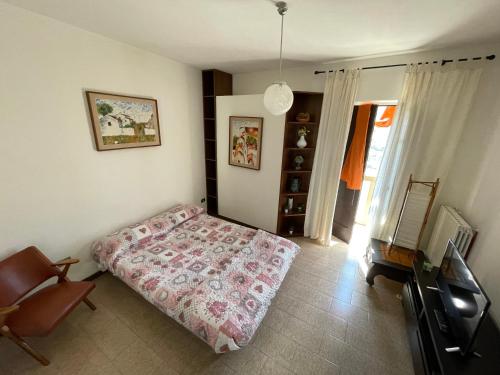 a bedroom with a bed and a chair in it at Casa Jolanda in Forlì del Sannio